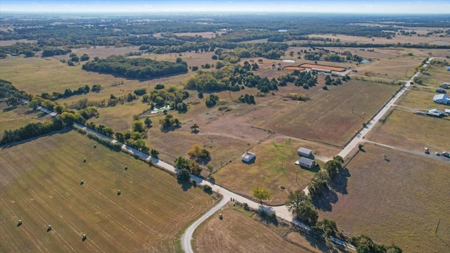 birds eye view of property with a rural view