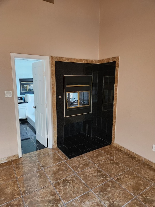 foyer featuring dark tile patterned flooring