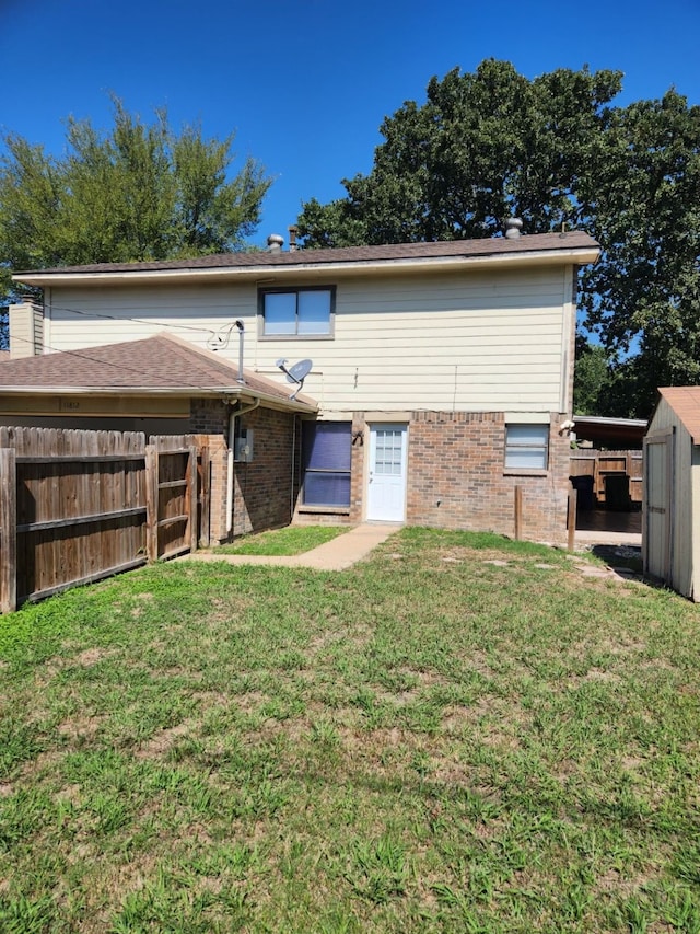 rear view of property featuring a lawn