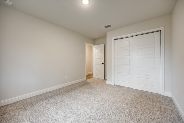 unfurnished bedroom featuring a closet and carpet