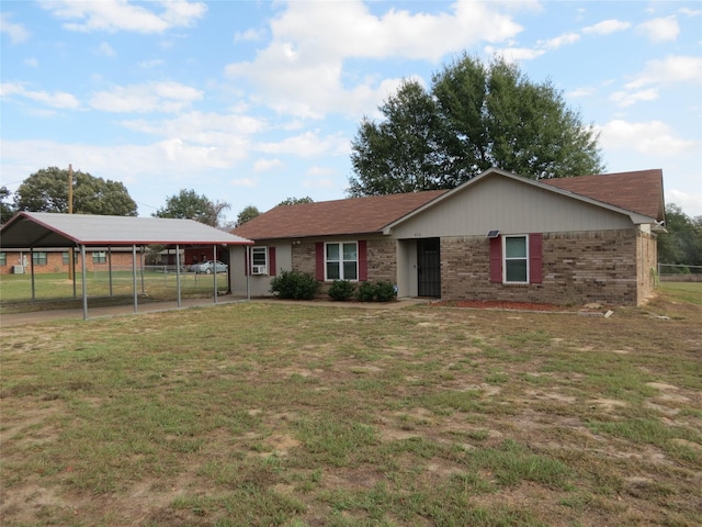 ranch-style home featuring a carport and a front yard