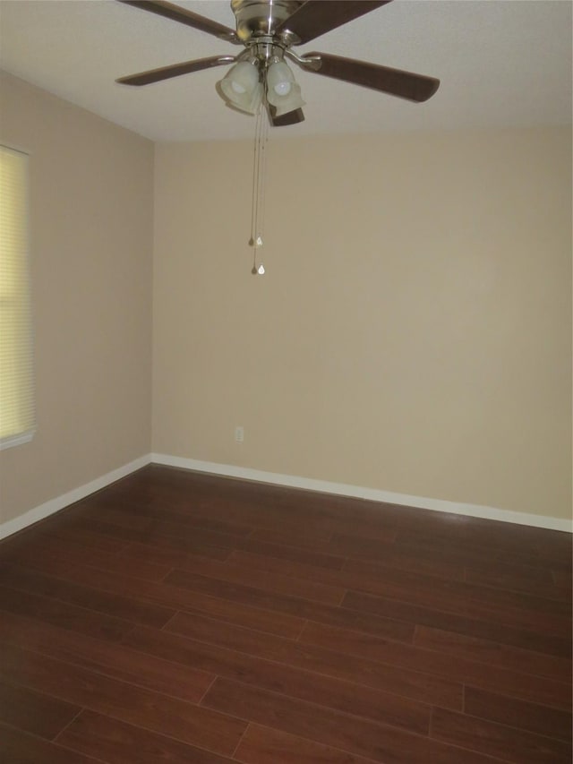 spare room featuring dark wood-type flooring and ceiling fan