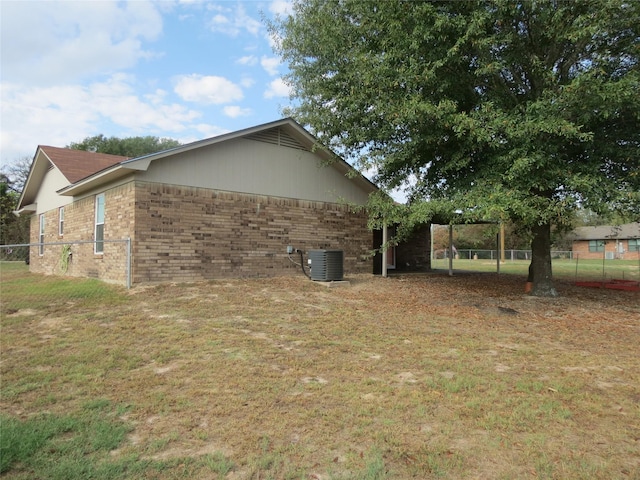 view of home's exterior featuring a yard and central AC unit