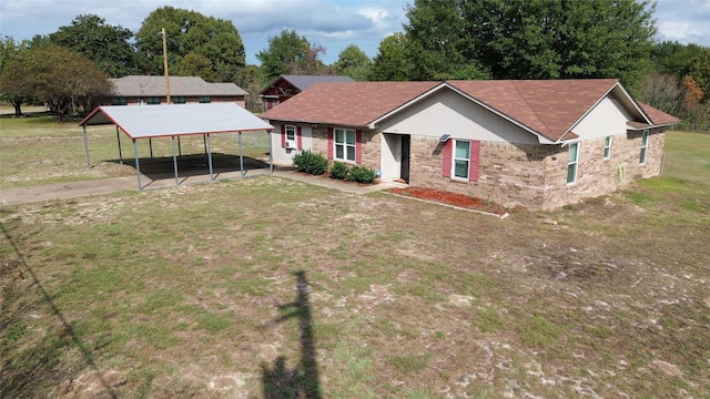 view of front facade with a carport and a front lawn