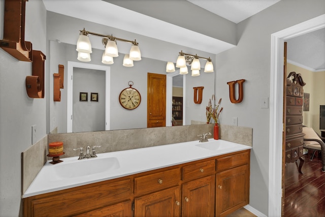 bathroom featuring vanity, ornamental molding, and hardwood / wood-style flooring