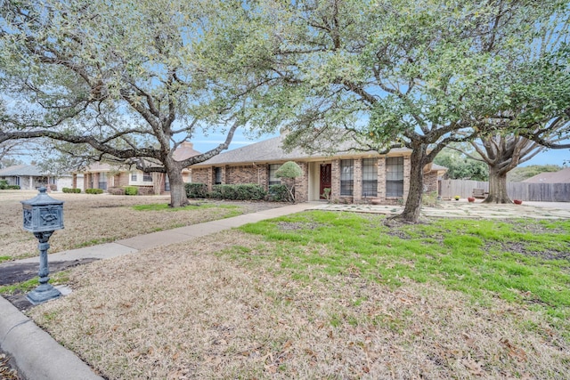 ranch-style home featuring a front yard