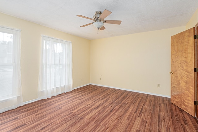 spare room featuring a textured ceiling, dark hardwood / wood-style floors, and ceiling fan