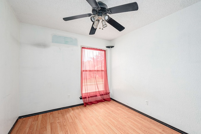 spare room with ceiling fan, hardwood / wood-style flooring, and a textured ceiling