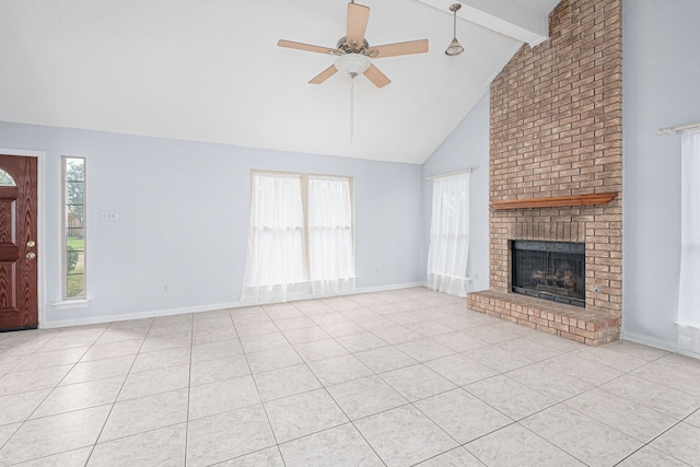 unfurnished living room featuring ceiling fan, a healthy amount of sunlight, beamed ceiling, and a brick fireplace