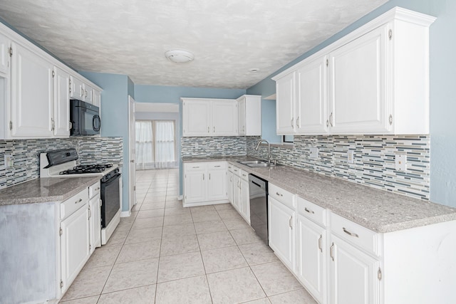 kitchen with decorative backsplash, white cabinetry, sink, and white gas range oven