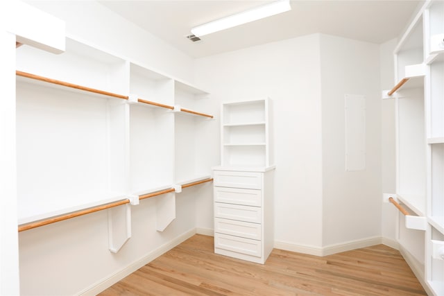 spacious closet featuring light hardwood / wood-style floors