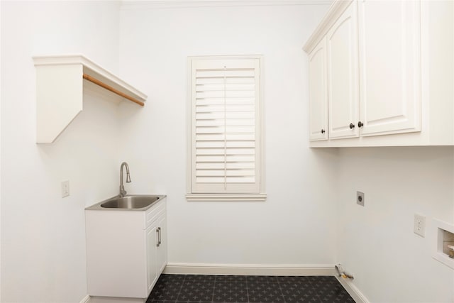 laundry room featuring hookup for an electric dryer, cabinets, and sink