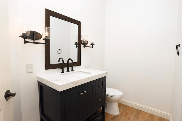 bathroom featuring hardwood / wood-style floors, vanity, and toilet