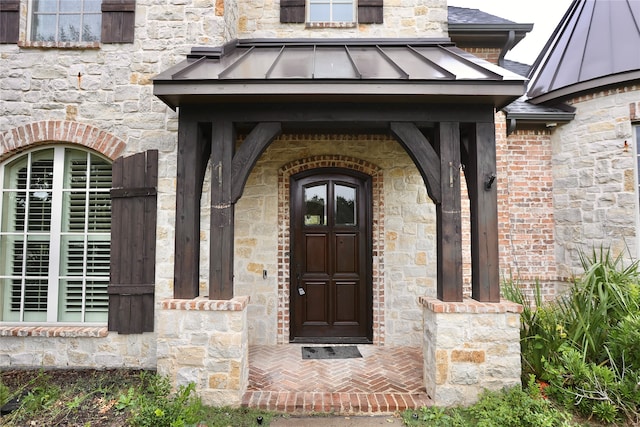 view of exterior entry featuring a porch