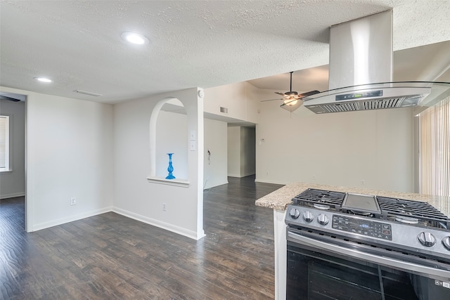 kitchen featuring dark wood-type flooring, gas stove, a textured ceiling, and island range hood