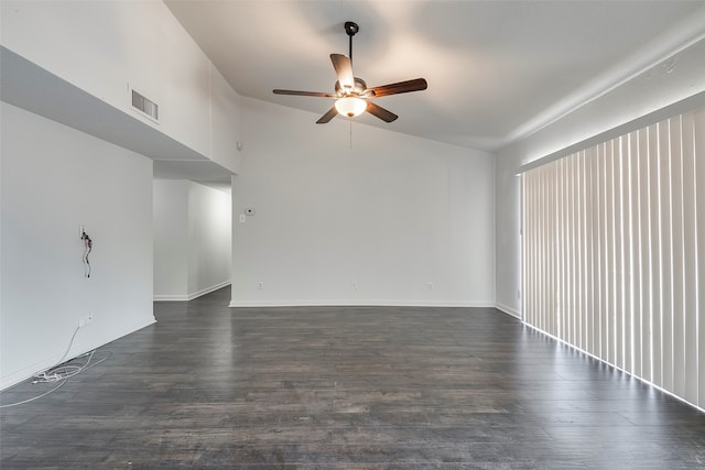 unfurnished room with ceiling fan, vaulted ceiling, and dark hardwood / wood-style floors