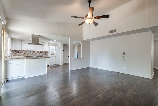 unfurnished living room with ceiling fan, high vaulted ceiling, sink, and dark hardwood / wood-style flooring