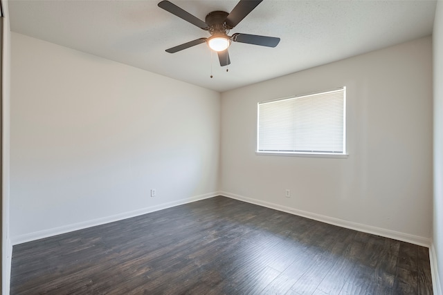 spare room featuring ceiling fan and dark hardwood / wood-style floors