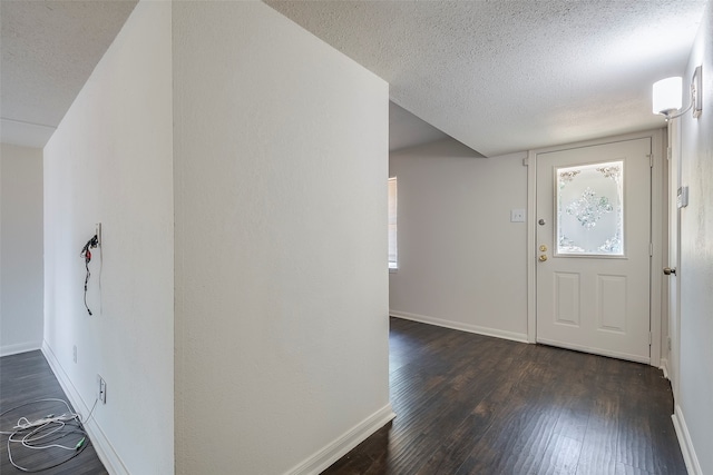 foyer with dark hardwood / wood-style floors and a textured ceiling