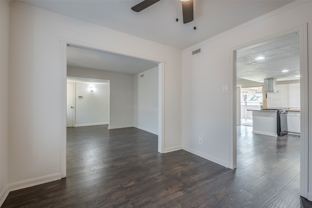 unfurnished room featuring crown molding, dark hardwood / wood-style floors, a textured ceiling, and ceiling fan