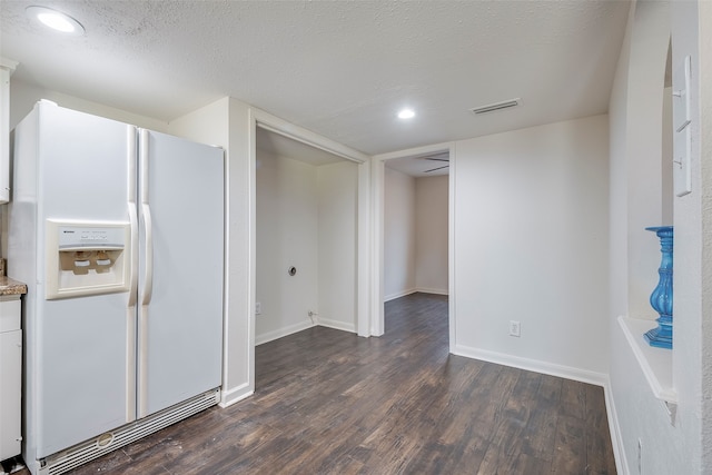 kitchen with white fridge with ice dispenser, a textured ceiling, and dark wood-type flooring