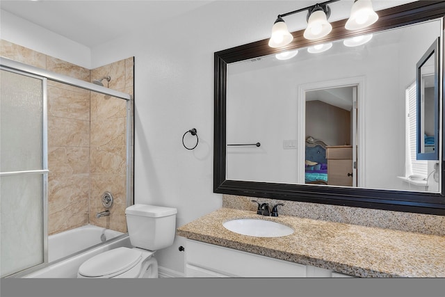 full bathroom with toilet, vanity, and shower / bath combination with glass door