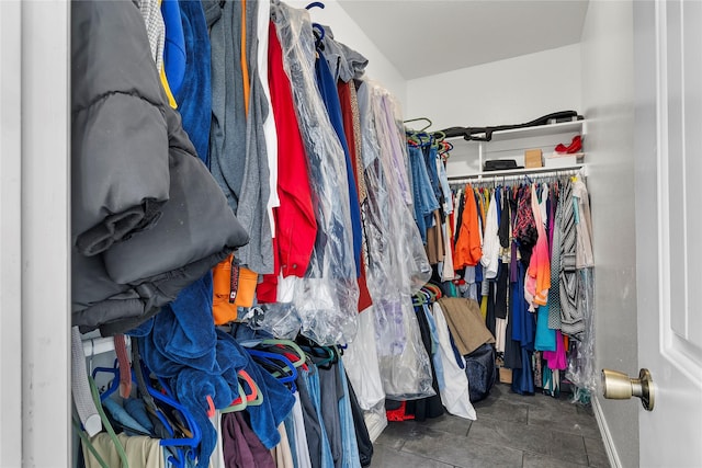 walk in closet featuring dark tile patterned floors