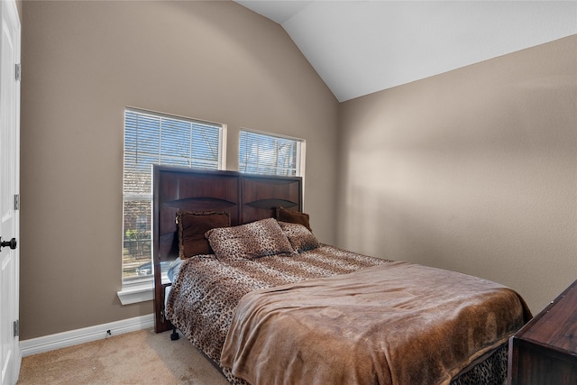 bedroom featuring lofted ceiling and light colored carpet