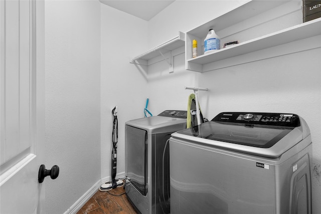 laundry area with dark wood-type flooring and washing machine and clothes dryer