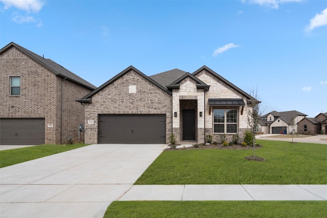 view of front of property with a front yard, concrete driveway, brick siding, and an attached garage