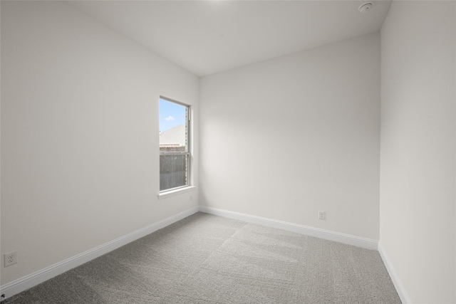 unfurnished room featuring baseboards and carpet flooring