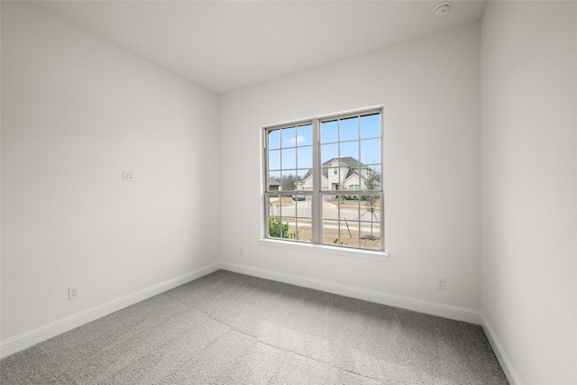 empty room with carpet and baseboards