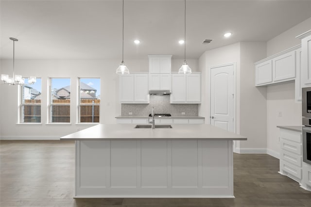 kitchen with visible vents, tasteful backsplash, and light countertops