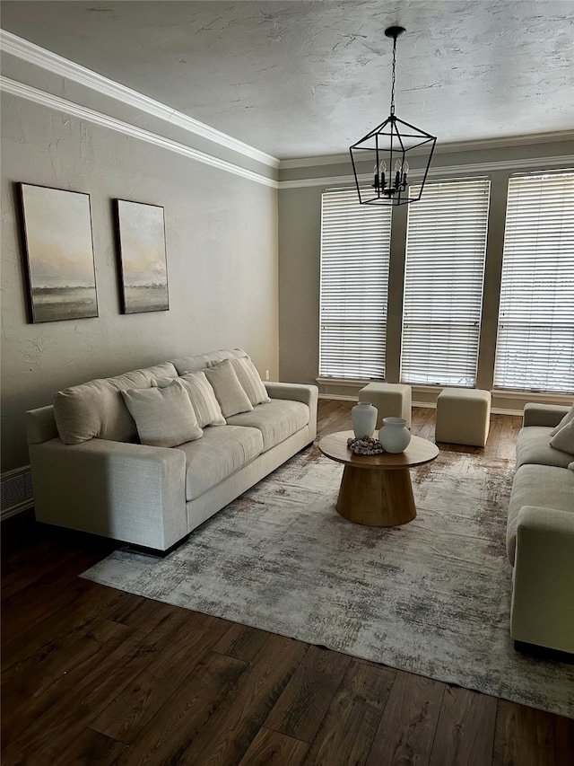 unfurnished living room with a wealth of natural light, a chandelier, crown molding, and hardwood / wood-style flooring