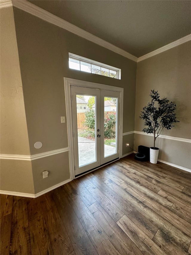 entryway with french doors, ornamental molding, and wood-type flooring