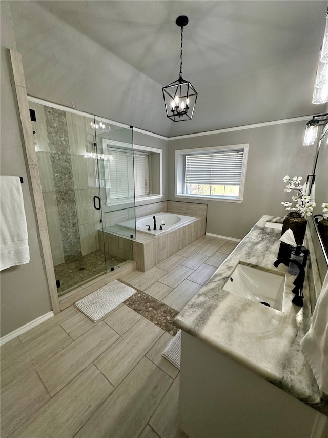 bathroom featuring independent shower and bath, lofted ceiling, vanity, ornamental molding, and a chandelier