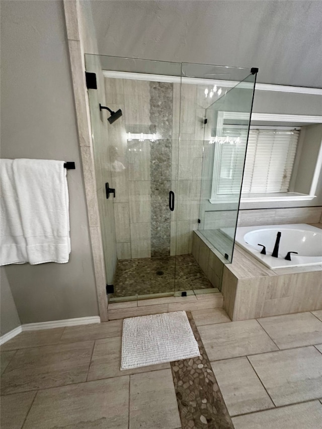 bathroom with independent shower and bath and tile patterned floors