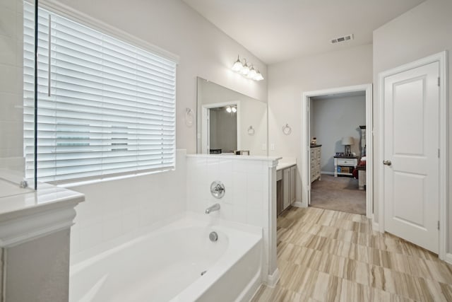 bathroom featuring a bathing tub and vanity