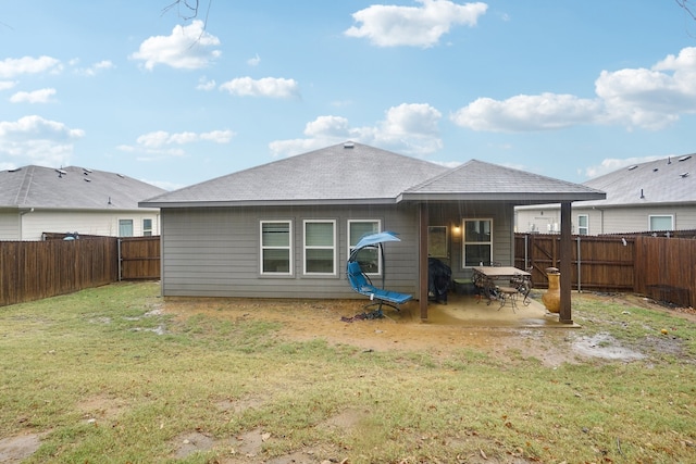 back of property featuring a patio area and a lawn