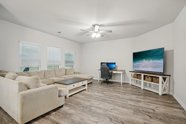 living room featuring hardwood / wood-style flooring and ceiling fan