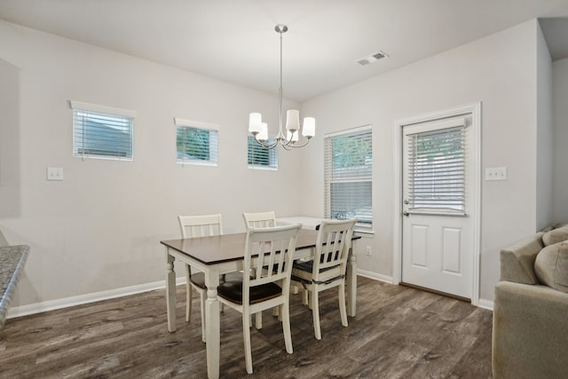 dining room featuring dark hardwood / wood-style flooring and a notable chandelier