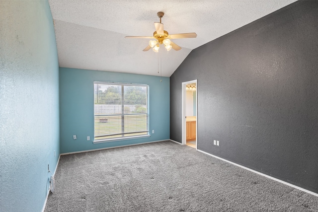 carpeted empty room featuring lofted ceiling, a textured ceiling, and ceiling fan