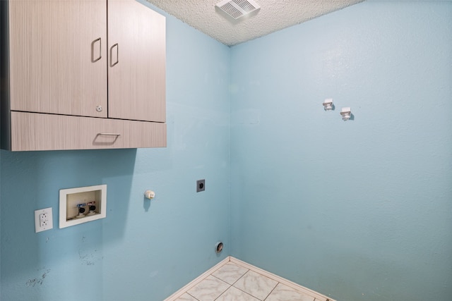 laundry room with cabinets, washer hookup, a textured ceiling, hookup for an electric dryer, and light tile patterned floors