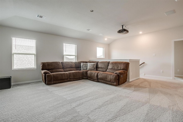 carpeted living room featuring lofted ceiling and plenty of natural light