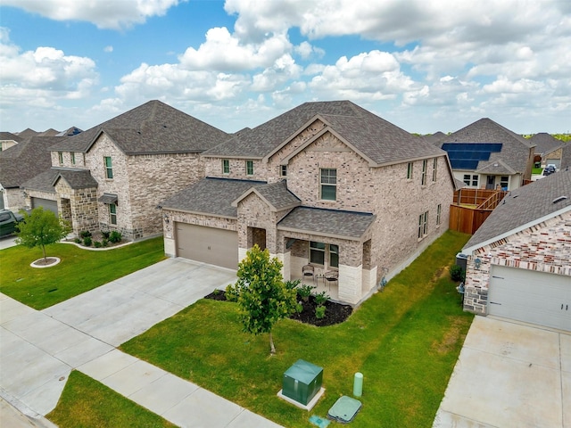 view of front of house featuring a front lawn and a garage