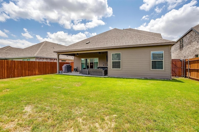 back of house featuring a patio, an outdoor living space, and a yard