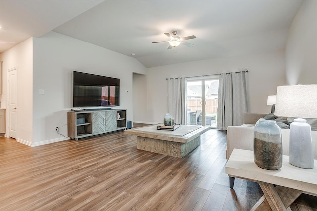 living room with ceiling fan, wood-type flooring, and vaulted ceiling