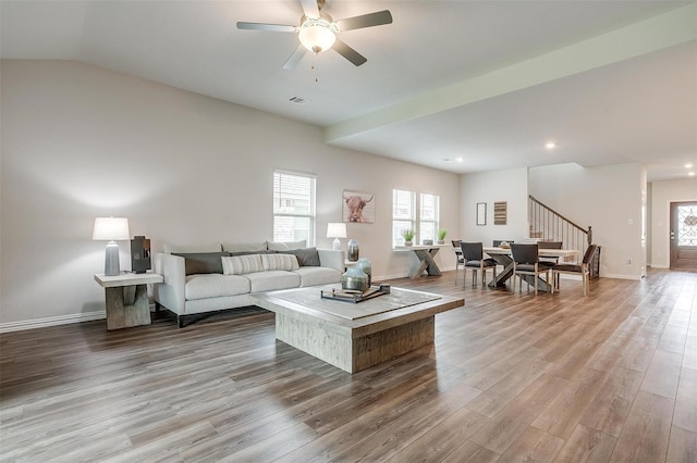 living room featuring vaulted ceiling, wood-type flooring, and ceiling fan