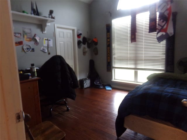 bedroom with dark wood-type flooring