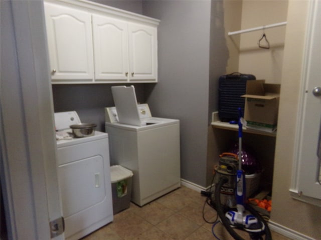 laundry area with cabinets, light tile patterned floors, and separate washer and dryer